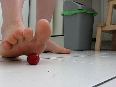 So she crushes it under her beautiful bare soles Her feet are covered in 
