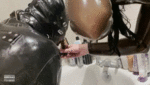 Rubber gimp drinks piss enema from three people