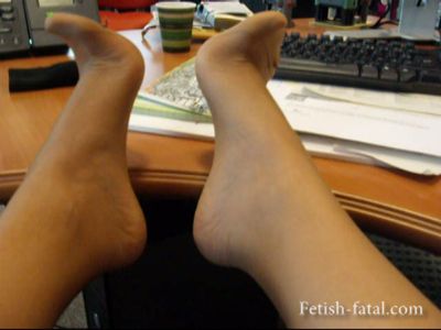 49955 - She shows off her feet under her desk with nylon stockings then repettos