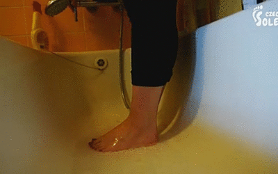 127972 - Young girl washing and brushing her bare feet