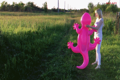 143596 - Alla walks with a rare inflatable lizard.