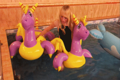 146328 - Hot ride on an inflatable magic dragon in the pool.