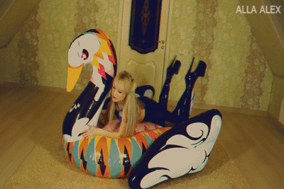 189426 - Alla is playing with a big inflatable swan.