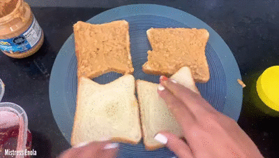 148793 - ENOLAS PEANUT BUTTER JELLY SANDWICH - Preparing Peanut butter jelly sandwich with hands and making him lick each finger and then feeding the 
