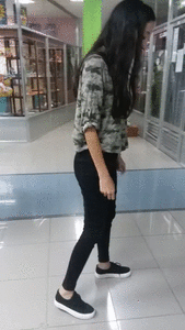 155818 - Venezuelian girl learning how to spit in a mall