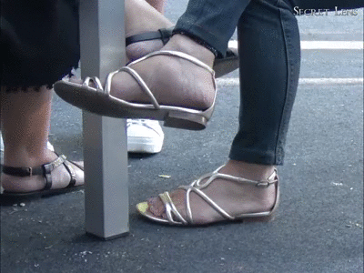 156302 - Under table floor tapping with her sandals