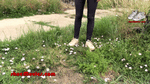 Young woman in Puma sneakers walk over flowers and plants 2