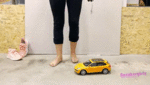 Toy car under her bare feet